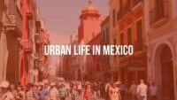 Busy urban street in Mexico, colorful buildings, bustling crowd, vibrant atmosphere, realistic.